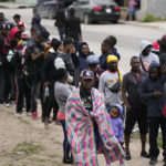 
              Haitian migrants hoping to apply for asylum in the U.S., gather along the U.S. Mexico border, as they wait to register with a religious organization, in Reynosa, Mexico, Wednesday, Dec. 21, 2022. (AP Photo/Fernando Llano)
            