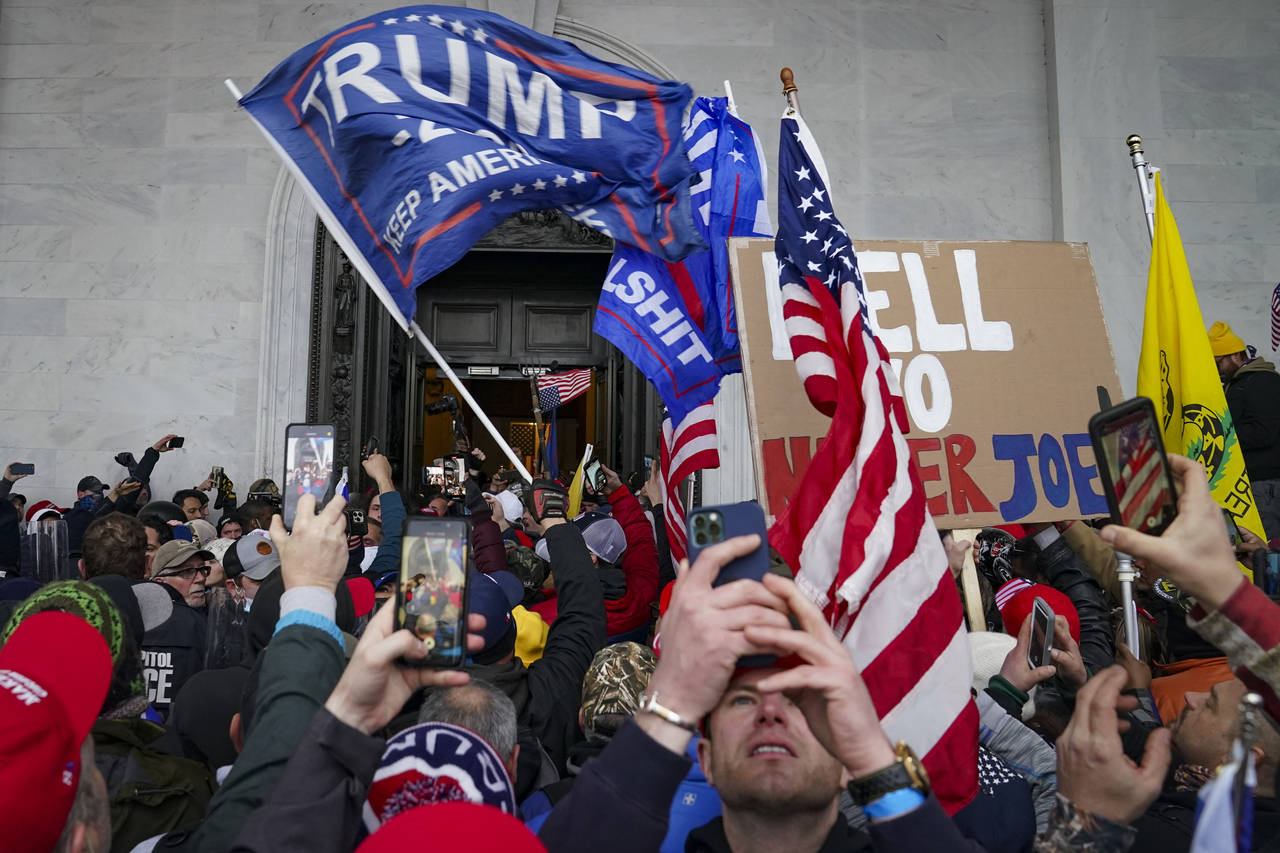 FILE - Insurrections loyal to President Donald Trump riot outside the Capitol in Washington, on Jan...