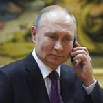 
              Russian President Vladimir Putin talks on the phone to eight-year-old Alexandra Titarenko from Zaporizhzhia region, a participant in the Fir Tree of Wishes charity campaign at the State Russian Museum in St. Petersburg, Russia, Tuesday, Dec. 27, 2022. (Alexey Danichev, Sputnik, Kremlin Pool Photo via AP)
            
