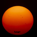 
              A commercial aircraft approaches the runway as the sun sets for the last time in 2022, in New Delhi, India, Saturday, Dec. 31, 2022. (AP Photo/Altaf Qadri)
            