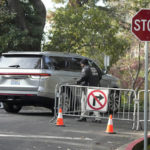 
              A vehicle allowed to pass drives past a guard closing barricades to a street near the family home of FTX founder Sam Bankman-Fried in Palo Alto, Calif., Friday, Dec. 23, 2022. Bankman-Fried's parents agreed to sign a $250 million bond and keep him at their California home while he awaits trial on charges that he swindled investors and looted customer deposits on his FTX trading platform. (AP Photo/Jeff Chiu)
            