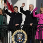 
              President Joe Biden and first lady Jill Biden with French President Emmanuel Macron and his wife Brigitte Macron wave from the Blue Room Balcony during a State Arrival Ceremony on the South Lawn of the White House in Washington, Thursday, Dec. 1, 2022. (AP Photo/Alex Brandon)
            