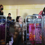 
              Single mothers and their children crowd into a room with bunk beds at a shelter Wednesday, Dec. 21, 2022, in Tijuana, Mexico. Thousands of migrants gathered along the Mexican side of the southern border Wednesday, camping outside or packing into shelters as they waited for the U.S. Supreme Court to decide whether and when to lift pandemic-era restrictions that have prevented many from seeking asylum. (AP Photo/Marcio Jose Sanchez)
            