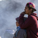 
              A migrant couple looks towards the border fence trying to decide whether or not to cross the Rio Grande River in their attempt to enter into El Paso, Texas from Ciudad Juarez, Mexico, Wednesday, Dec. 21, 2022. Thousands of migrants gathered along the Mexican side of the southern border Wednesday, camping outside or packing into shelters as they waited for the U.S. Supreme Court to decide whether and when to lift pandemic-era restrictions that have prevented many from seeking asylum. (AP Photo/Andres Leighton)
            