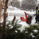 
              A worker operates a snowblower outside a hotel in Ottawa, as a winter storm warning is in effect, on Friday, Dec. 23, 2022. (Justin Tang /The Canadian Press via AP)
            