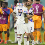 
              Christian Pulisic of the United States, left, is comforted by teammate Cristian Roldan at the end of the World Cup round of 16 soccer match between the Netherlands and the United States, at the Khalifa International Stadium in Doha, Qatar, Saturday, Dec. 3, 2022. (AP Photo/Ashley Landis)
            