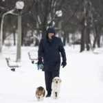
              A person walks his dog along the Rideau River in the Sandy Hill neighborhood of Ottawa, on Friday, Dec. 23, 2022. Environment Canada has issued a winter storm warning for the region which is calling for flash freezing, icy and slippery surfaces, wind gusts and chills. (Spencer Colby /The Canadian Press via AP)
            