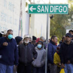 
              A line of people, some migrants and some homeless, await a hot breakfast Wednesday, Dec. 21, 2022, in Tijuana, Mexico. Thousands of migrants gathered along the Mexican side of the southern border Wednesday, camping outside or packing into shelters as they waited for the U.S. Supreme Court to decide whether and when to lift pandemic-era restrictions that have prevented many from seeking asylum. (AP Photo/Marcio Jose Sanchez)
            