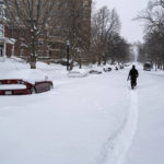 
              Daniel Shafer of Buffalo, N.Y., walks along a path in the street in the Elmwood Village neighborhood of Buffalo, Monday, Dec. 26, 2022, after a massive snow storm blanketed the city. Along with drifts and travel bans, many streets were impassible due to abandoned vehicles. (AP Photo/Craig Ruttle)
            