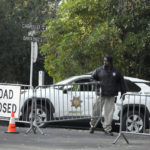 
              A guard closes barricades to a street near the family home of FTX founder Sam Bankman-Fried in Palo Alto, Calif., Friday, Dec. 23, 2022. Bankman-Fried's parents agreed to sign a $250 million bond and keep him at their California home while he awaits trial on charges that he swindled investors and looted customer deposits on his FTX trading platform. (AP Photo/Jeff Chiu)
            