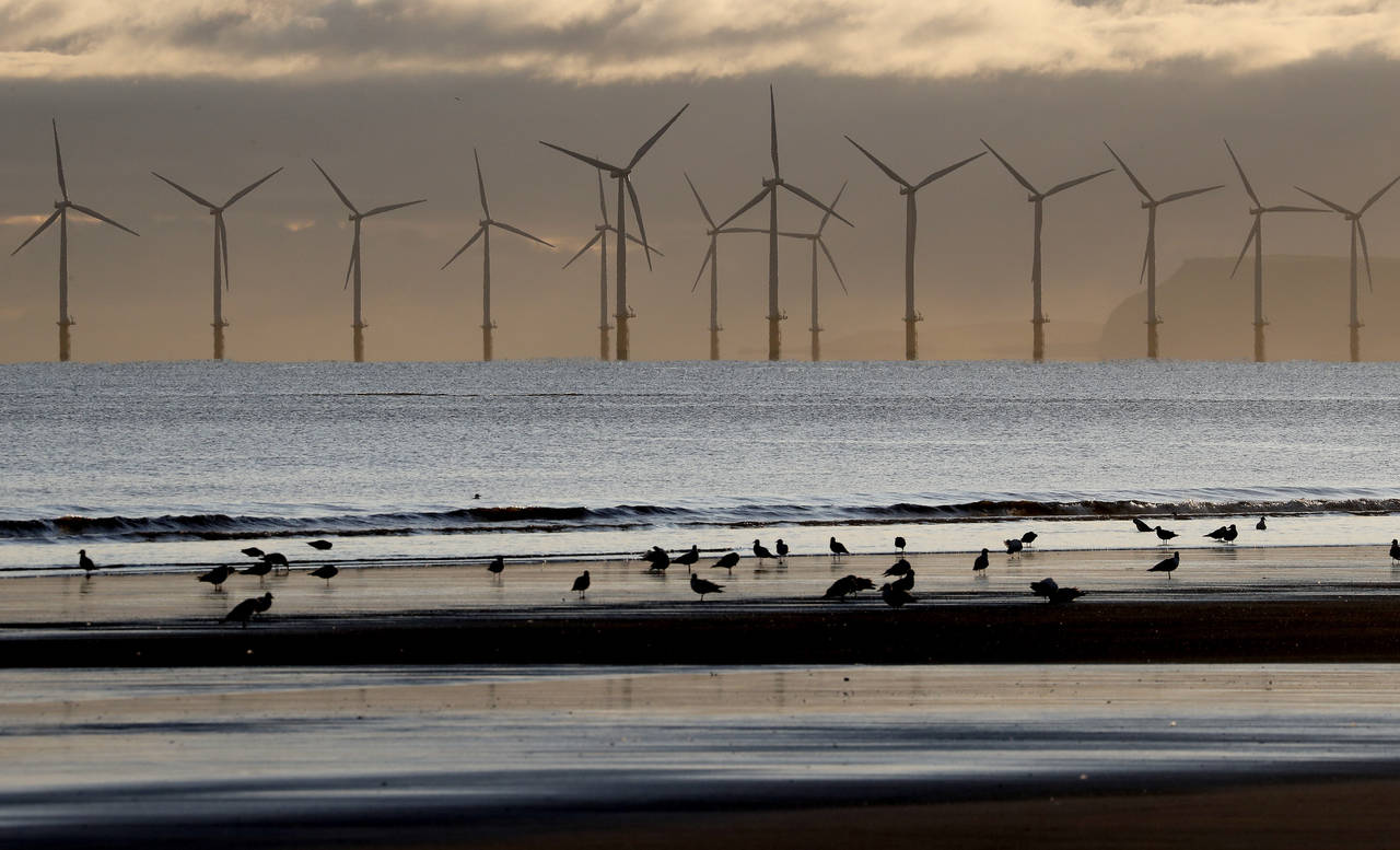 FILE - An offshore wind farm is visible from the beach in Hartlepool, England, Tuesday, Nov. 12, 20...