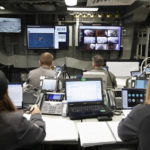 
              Video feeds are displayed in the U.S.S. Portland command center during recovery operations after NASA's Orion Capsule splashed down in the Pacific off Mexico, Sunday, Dec. 11, 2022. NASA’s Orion capsule made a blisteringly fast return from the moon Sunday, to conclude a test flight that should clear the way for astronauts on the next lunar flyby. (Caroline Brehman/Pool Photo via AP)
            
