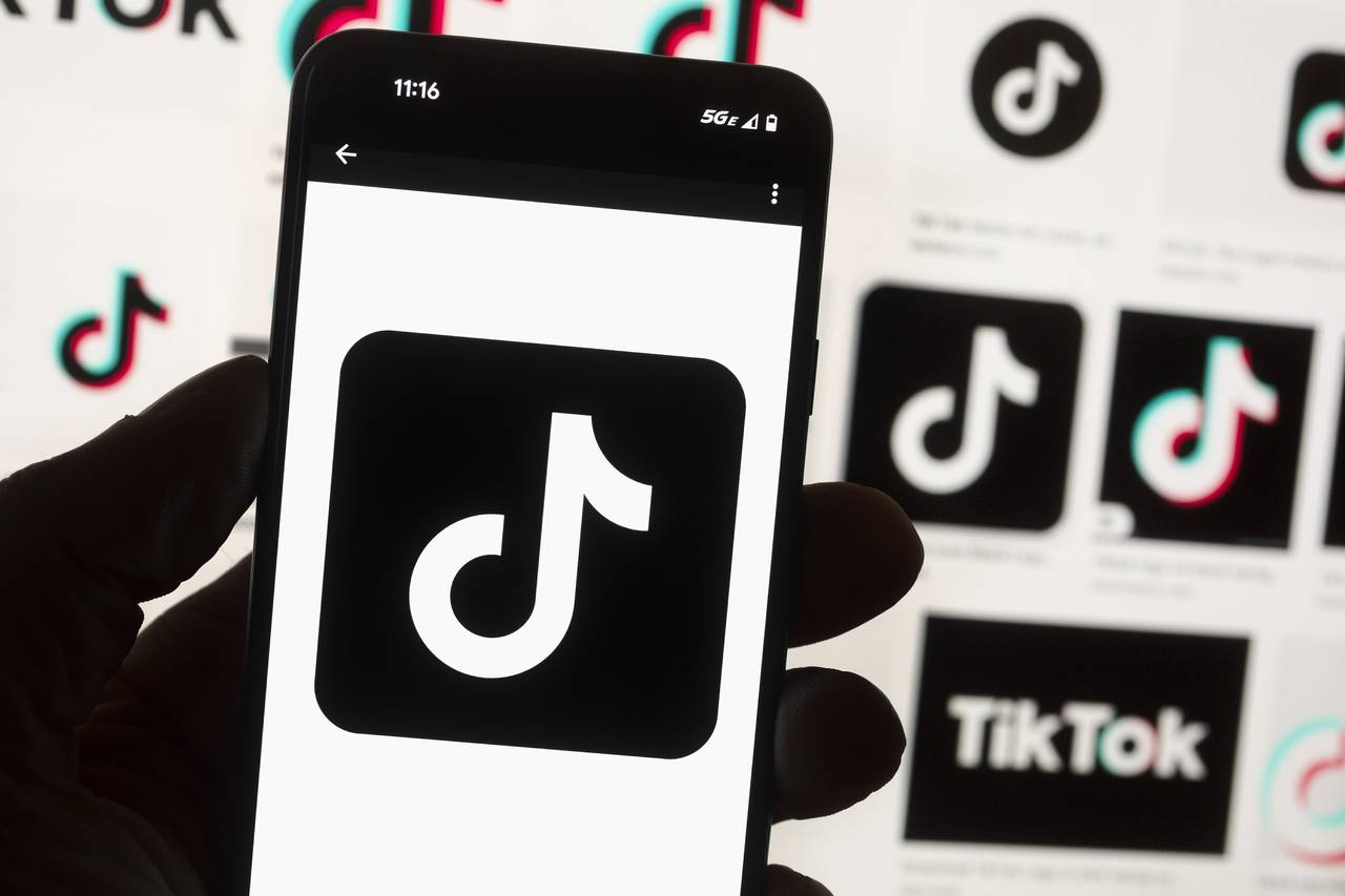 FILE - The TikTok logo is seen on a cell phone on Oct. 14, 2022, in Boston. Kansas Gov. Laura Kelly...