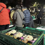 
              Volunteers hand out free meals for the homeless at a Tokyo park on New Year's Eve on Saturday, Dec. 31, 2022. (AP Photo/Yuri Kageyama)
            