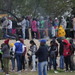 
              Haitian migrants who hope to apply for asylum in the U.S. wait to register their names on a list made by a religious organization in Reynosa, Mexico, Wednesday, Dec. 21, 2022, on the other side of the border with McAllen, Texas. (AP Photo/Fernando Llano)
            