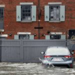 
              Water floods a parking lot on Long Wharf during high tide, Friday, Dec. 23, 2022, in Boston. Winter weather is blanketing the U.S. More than 200 million people — about 60% of the U.S. population — were under some form of winter weather advisory or warning on Friday. (AP Photo/Michael Dwyer)
            