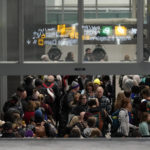 
              Travelers wait in line to go through security in Terminal 1 at Minneapolis St. Paul Airport, Wednesday, Dec. 21, 2022, in Minneapolis. (AP Photo/Abbie Parr)
            