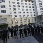 
              Riot police flank the exterior of a federal court building after judges announced the sentence and verdict in a conspiracy and fraud trial against Vice President Cristina Fernandez, a former president, in Buenos Aires, Argentina, Tuesday, Dec. 6, 2022. The court sentenced Fernandez to 6 years in prison and a lifetime ban from holding public office. Fernandez is accused of running a criminal organization that defrauded the state of $1 billion during her presidency through public works contracts granted to a construction magnate closely tied to her family. (AP Photo/Rodrigo Abd)
            