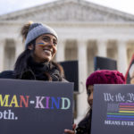 
              Pro-gay rights supporter Amrita Bhowmick and her daughter Maya, 10, stand outside the Supreme Court in Washington, Monday, Dec. 5, 2022. The Supreme Court is hearing the case of a Christian graphic artist who objects to designing wedding websites for gay couples, that's the latest clash of religion and gay rights to land at the highest court. (AP Photo/Andrew Harnik)
            