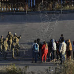 
              U.S. military stop migrants from crossing into El Paso, Texas, seen from Ciudad Juarez, Mexico, Tuesday, Dec. 20, 2022. The U.S. Supreme Court issued a temporary order to keep pandemic-era limits on asylum-seekers in place, though it could be brief, as conservative-leaning states push to maintain a measure that allows officials to expel many but not all asylum-seekers. (AP Photo/Christian Chavez)
            
