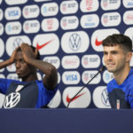 
              Tim Weah, left, and Christian Pulisic, both of the United States, attend a press conference before a training session at Al-Gharafa SC Stadium, in Doha, Thursday, Dec. 1, 2022. (AP Photo/Ashley Landis)
            