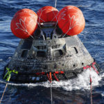 
              NASA's Orion capsule makes its way toward the U.S.S. Portland after being successfully secured by a NASA and U.S. Navy team in the Pacific off Mexico, Sunday, Dec. 11, 2022, concluding a 25-day test flight. The mission should clear the way for astronauts on the program’s next lunar flyby, set for 2024. (Caroline Brehman/Pool Photo via AP)
            