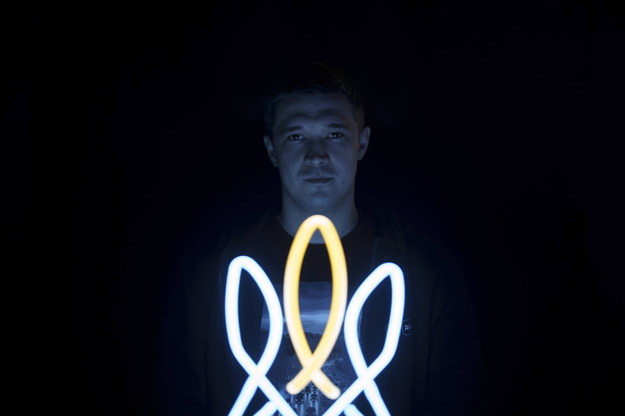 Mykhailo Fedorov, Ukrainian minister of digital transformation, poses for a photo illuminated by a ...