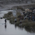 
              Migrants cross the Rio Grande towards the U.S.-Mexico border in Ciudad Juarez, Mexico, Tuesday, Dec. 20, 2022. Tensions remained high at the U.S-Mexico border Tuesday amid uncertainty over the future of restrictions on asylum-seekers, with the Biden administration asking the Supreme Court not to lift the limits before Christmas. (AP Photo/Christian Chavez)
            