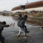 
              Migrants cross the Rio Grande towards the U.S.-Mexico border in Ciudad Juarez, Mexico, Tuesday, Dec. 20, 2022. The U.S. Supreme Court issued a temporary order to keep pandemic-era limits on asylum-seekers in place, though it could be brief, as conservative-leaning states push to maintain a measure that allows officials to expel many but not all asylum-seekers. (AP Photo/Christian Chavez)
            