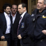 
              FTX founder Sam Bankman-Fried, left, is escorted to his car from the U.S. District Court in Manhattan, Thursday, Dec. 22, 2022, in New York. Bankman-Fried's parents agreed to sign a $250 million bond and keep him at their California home while he awaits trial on charges that he swindled investors and looted customer deposits on his FTX trading platform. (AP Photo/Julia Nikhinson)
            