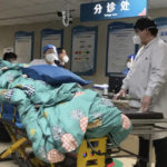 A patient is turned away from the emergency room due to full capacity at the Baoding No. 2 Central Hospital in Zhuozhou city in northern China's Hebei province on Wednesday, Dec. 21, 2022. China only counts deaths from pneumonia or respiratory failure in its official COVID-19 death toll, a Chinese health official said, in a narrow definition that limits the number of deaths reported, as an outbreak of the virus surges following the easing of pandemic-related restrictions. (AP Photo/Dake Kang)