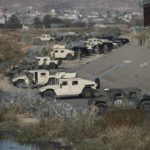 
              U.S. military guard El Paso's border with Mexico, seen from Ciudad Juarez, Mexico, Tuesday, Dec. 20, 2022. The Supreme Court issued a temporary order to keep pandemic-era limits on asylum-seekers in place, though it could be brief, as conservative-leaning states push to maintain a measure that allows officials to expel many but not all asylum-seekers. (AP Photo/Christian Chavez)
            