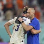 
              head coach Gregg Berhalter of the United States, right, hugs with Walker Zimmerman of the United States at the end of the World Cup round of 16 soccer match between the Netherlands and the United States, at the Khalifa International Stadium in Doha, Qatar, Saturday, Dec. 3, 2022. (AP Photo/Natacha Pisarenko)
            