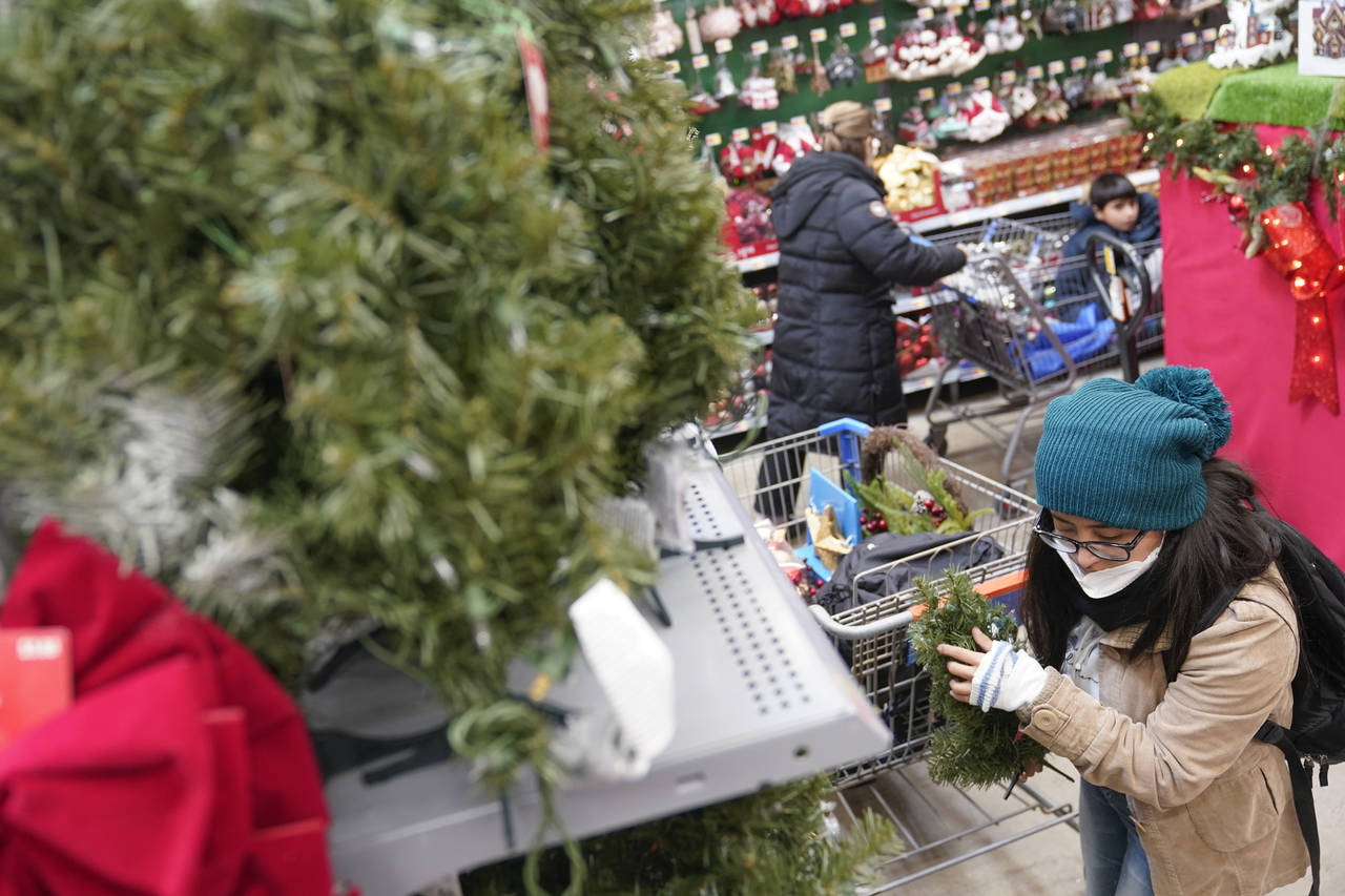 FILE - Andrea Mena shops in the holiday section of a Walmart in Secaucus, N.J., Tuesday, Nov. 22, 2...
