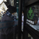 
              Residents line up for medicine at a pharmacy in Beijing, Friday, Dec. 9, 2022. China began implementing a more relaxed version of its strict "zero COVID" policy on Thursday amid steps to restore normal life, but also trepidation over a possible broader outbreak once controls are eased. (AP Photo/Ng Han Guan)
            