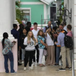 
              A handful of crypto enthusiasts and FTX investors wait to enter Magistrate Court to see a scheduled appearance by FTX founder Sam Bankman-Fried, in Nassau, Bahamas, Monday, Dec. 19, 2022. (AP Photo/Rebecca Blackwell)
            
