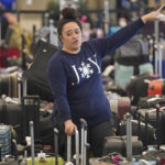 
              A Southwest Airlines employee looks for an unclaimed bag at Southwest Airlines baggage claim at Salt Lake City International Airport Thursday, Dec. 29, 2022, in Salt Lake City. Southwest Airlines is still trying to extract itself from sustained scheduling chaos and cancelled another 2,350 flights after a winter storm overwhelmed its operations days ago. (AP Photo/Rick Bowmer)
            