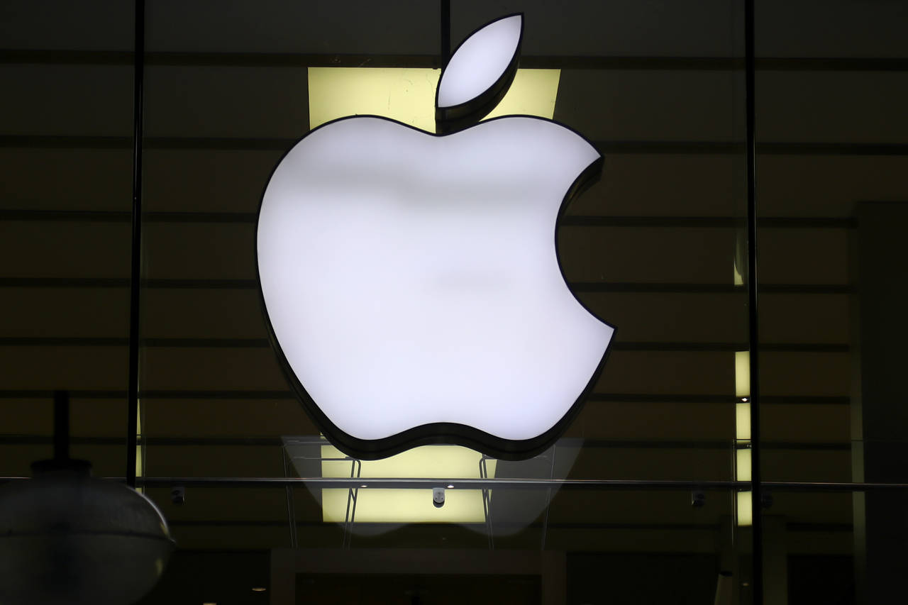 FILE - The Apple logo is illuminated at a store in the city center in Munich, Germany, on Dec. 16, ...