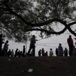 
              Haitian migrants hoping to apply for asylum in the U.S., gather along the U.S. Mexico border, as they wait to register with a religious organization, in Reynosa, Mexico, Wednesday, Dec. 21, 2022. (AP Photo/Fernando Llano)
            