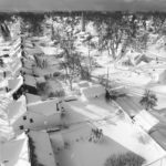
              In this drone image, snow blankets a neighborhood, Sunday, Dec. 25, 2022, in Cheektowaga, N.Y. Millions of people hunkered down against a deep freeze Sunday morning to ride out the frigid storm that has killed at least 24 people across the United States and is expected to claim more lives after trapping some residents inside houses with heaping snow drifts and knocking out power to several hundred thousand homes and businesses.(John Waller via AP)
            