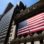 
              FILE - An American flag is displayed on the facade of the New York Stock Exchange on June 29, 2022, in New York. Investors had few places to hide in 2022: Stocks and bonds both nose-dived and crypto tanked. Pocketbook issues were front and center for consumers as prices for food, energy and rent jumped. (AP Photo/Julia Nikhinson, File)
            