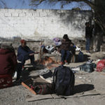 
              Migrants sit around a fire at a shelter on the U.S.-Mexico border in Ciudad Juarez, Mexico, Monday, Dec. 19, 2022. Pandemic-era immigration restrictions in the U.S. known as Title 42 are set to expire on Dec. 21. (AP Photo/Christian Chavez)
            