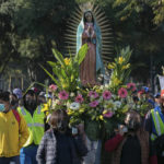 
              Devotees of the Virgin of Guadalupe walk to the Basilica to give thanks or worship a day before her national celebration in Mexico City, on Sunday, Dec. 11, 2022. (AP Photo/Ginnette Riquelme)
            