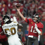
              Tampa Bay Buccaneers quarterback Tom Brady (12) passes under pressure from New Orleans Saints defensive end Tanoh Kpassagnon (90) in the first half of an NFL football game in Tampa, Fla., Monday, Dec. 5, 2022. (AP Photo/Chris O'Meara)
            