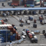 
              Cargo trucks move into a port in Busan, South Korea, Friday, Dec. 9, 2022. Thousands of South Korean truckers are returning to work after voting Friday to end their 16-day walkout that has disrupted construction and other domestic industries. (Kang Duck-chul/Yonhap via AP)
            