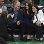 
              Massachusetts Gov.-Elect Maura Healey takes a photo of Britain's William and Kate, Princess of Wales, and Emilia Fazzalari, wife of Boston Celtics owner Wyc Grousbeck during a timeout in an NBA basketball game between the Boston Celtics and the Miami Heat in Boston, Wednesday, Nov. 30, 2022. (Jim Davis/The Boston Globe vai AP, Pool)
            