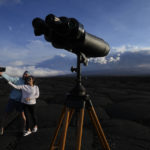 
              Jason, left, and Anakaren Pagan, of Memphis, take a picture near the Mauna Loa volcano as it erupts Wednesday, Nov. 30, 2022, near Hilo, Hawaii. (AP Photo/Gregory Bull)
            