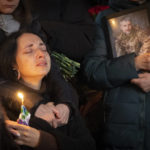 
              Relatives react at the coffin during the funeral ceremony of Volodymyr Yezhov killed in a battlefield with Russian forces at St. Volodymyr Cathedral in Kyiv, Ukraine, Tuesday, Dec. 27, 2022. Yezhov was a game designer in the development of the game Cossacks 2, one of the authors of the game S.T.A.L.K.E.R.: Clear Sky and also one of the most famous Ukrainian e-sportsmen — played StarCraft under the nickname Fresh. Since the Russian invasion, Volodymyr Yezhov went to the frontline and fought as part of the volunteer squadron. (AP Photo/Efrem Lukatsky)
            