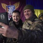 
              In this photo provided by the Ukrainian Presidential Press Office, Ukrainian soldier takes a selfie with President Volodymyr Zelenskyy, left, during his visit to Sloviansk, Donbas region, Ukraine, Tuesday, Dec. 6, 2022. (Ukrainian Presidential Press Office via AP)
            