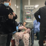 A patient rests in a wheelchair at the emergency department of the Langfang No. 4 People's Hospital in Bazhou city in northern China's Hebei province on Thursday, Dec. 22, 2022. As China grapples with its first-ever wave of COVID mass infections, emergency wards in the towns and cities to Beijing's southwest are overwhelmed. Intensive care units are turning away ambulances, residents are driving sick relatives from hospital to hospital, and patients are lying on floors for a lack of space. (AP Photo/Dake Kang)